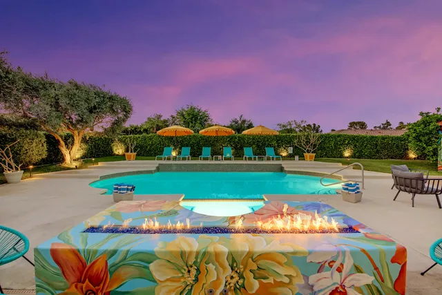 a view of a patio with chairs and a fire pit