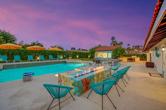 a view of a backyard with a patio and fire pit