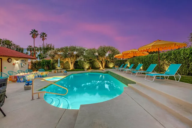 a kitchen with granite countertop a center island stainless steel appliances and wooden cabinets