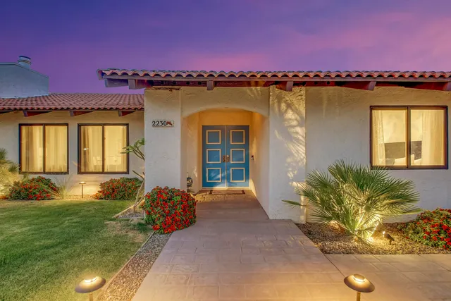 a front view of a house with garden