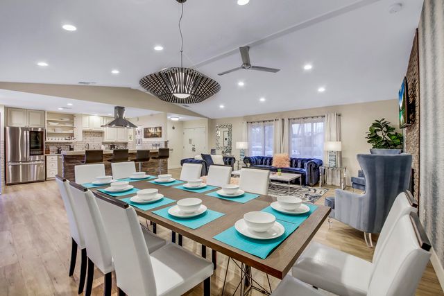 a bathroom with a granite countertop double vanity and a mirror