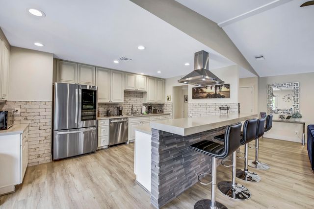 a bathroom with a granite countertop sink mirror and vanity