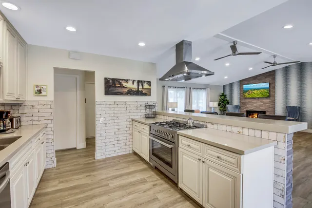 a bedroom with a bed table flowerpot and window