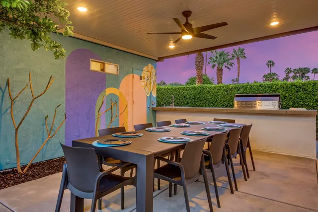 a view of a dining room with furniture and a potted plant