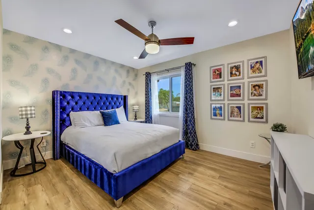 a bathroom with a granite countertop toilet sink and mirror