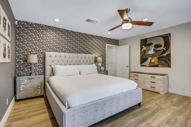 a view of a swimming pool with a lounge chairs in front of house