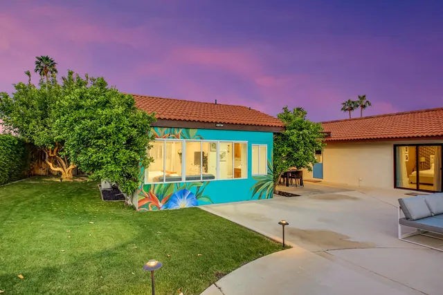 a view of a house with a backyard and a yard