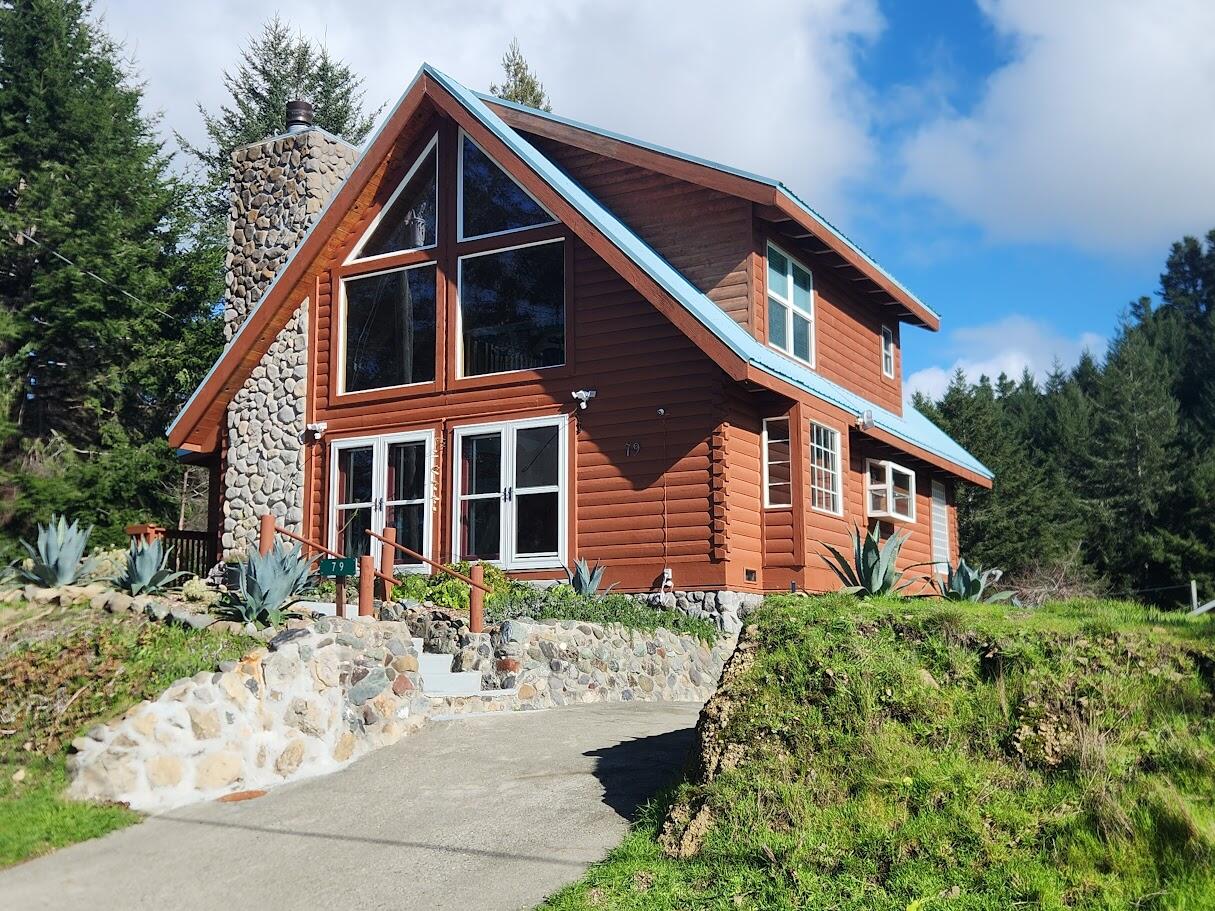 79 Ridge Road Whitethorn, CA 95589 - Photo 1 of 1 a front view of a house with a yard