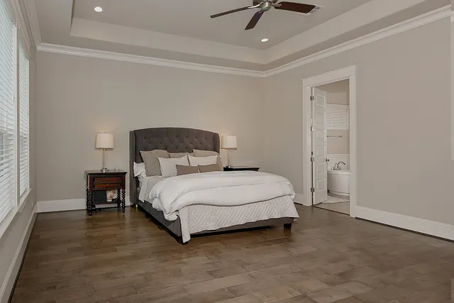 a bedroom with a bed and a ceiling fan