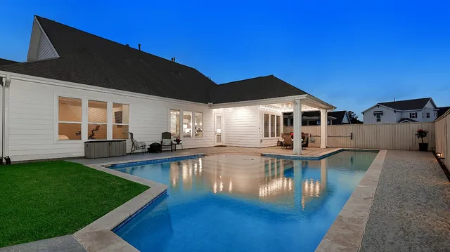 a front view of a house with swimming pool yard and outdoor seating