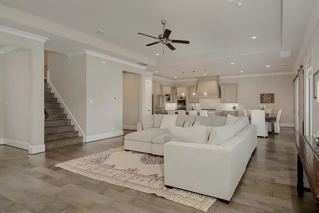 a living room with furniture and a wooden floor