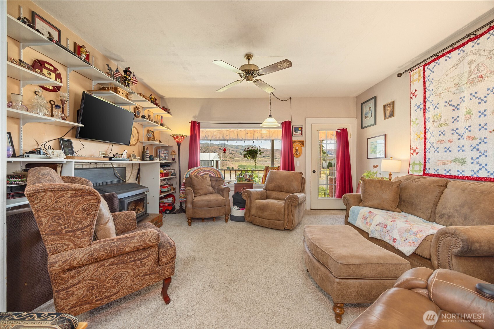 1281 Totem Pole Road Manson, WA 98831 - Photo 5 of 39 a living room with furniture a flat screen tv and a fireplace