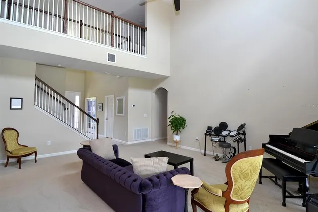 a living room with furniture and a potted plant