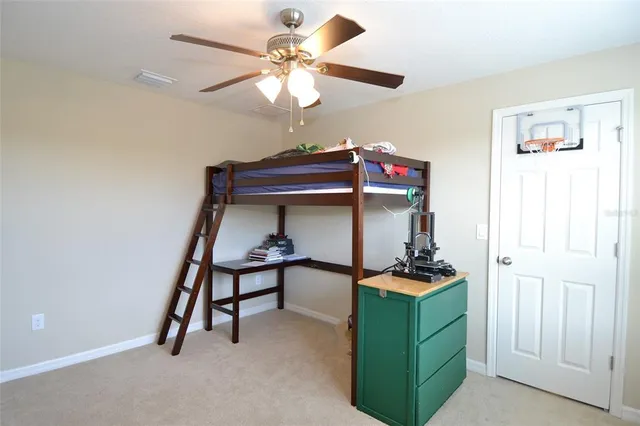 a living room with furniture and a ceiling fan