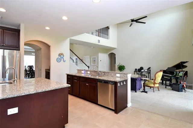 a large kitchen with kitchen island a sink and a wooden cabinets