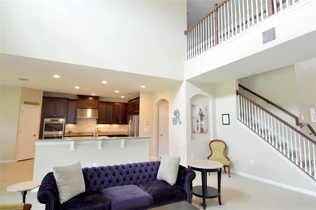 a living room with furniture and kitchen view