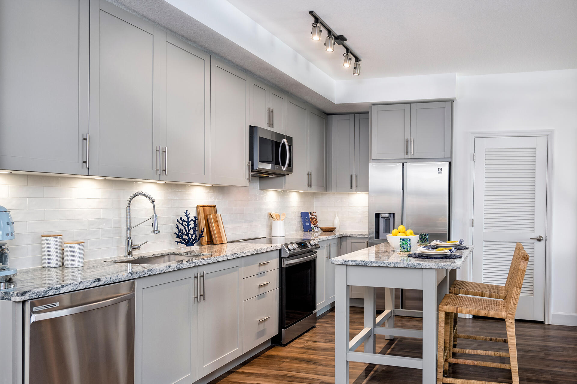 2000 Stirling Road, Unit 8102 Hollywood, FL 33020 - Photo 10 of 19 a kitchen with stainless steel appliances granite countertop a sink a stove a refrigerator cabinets and chairs