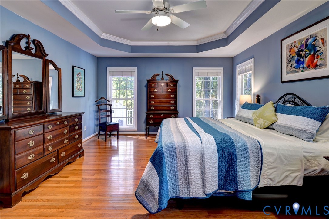 9405 Ashlock Court Toano, VA 23168 - Photo 19 of 43 a bedroom with a bed and wooden floor