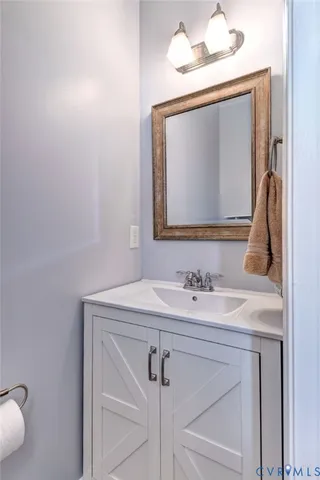 a bathroom with a sink vanity and a mirror