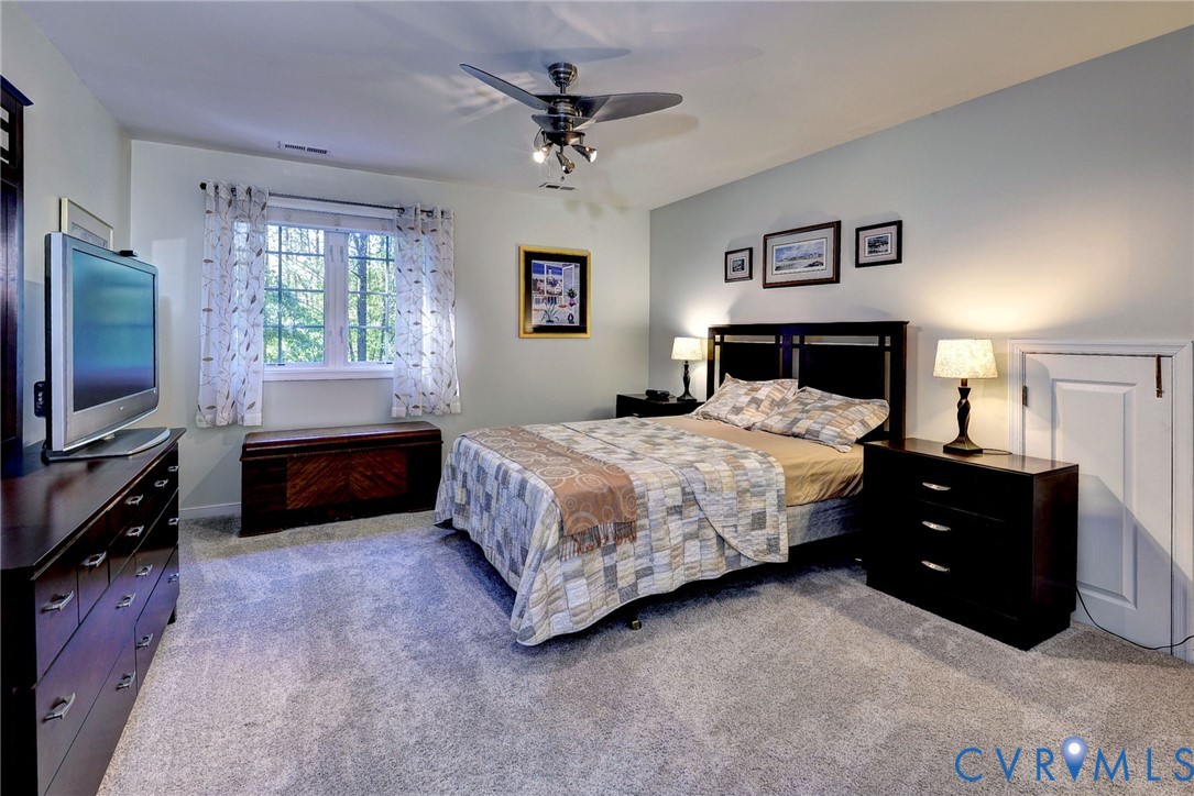 9405 Ashlock Court Toano, VA 23168 - Photo 26 of 43 a bedroom with a bed and a flat screen tv