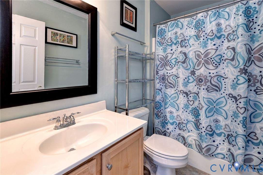 9405 Ashlock Court Toano, VA 23168 - Photo 27 of 43 a bathroom with a sink toilet and a mirror