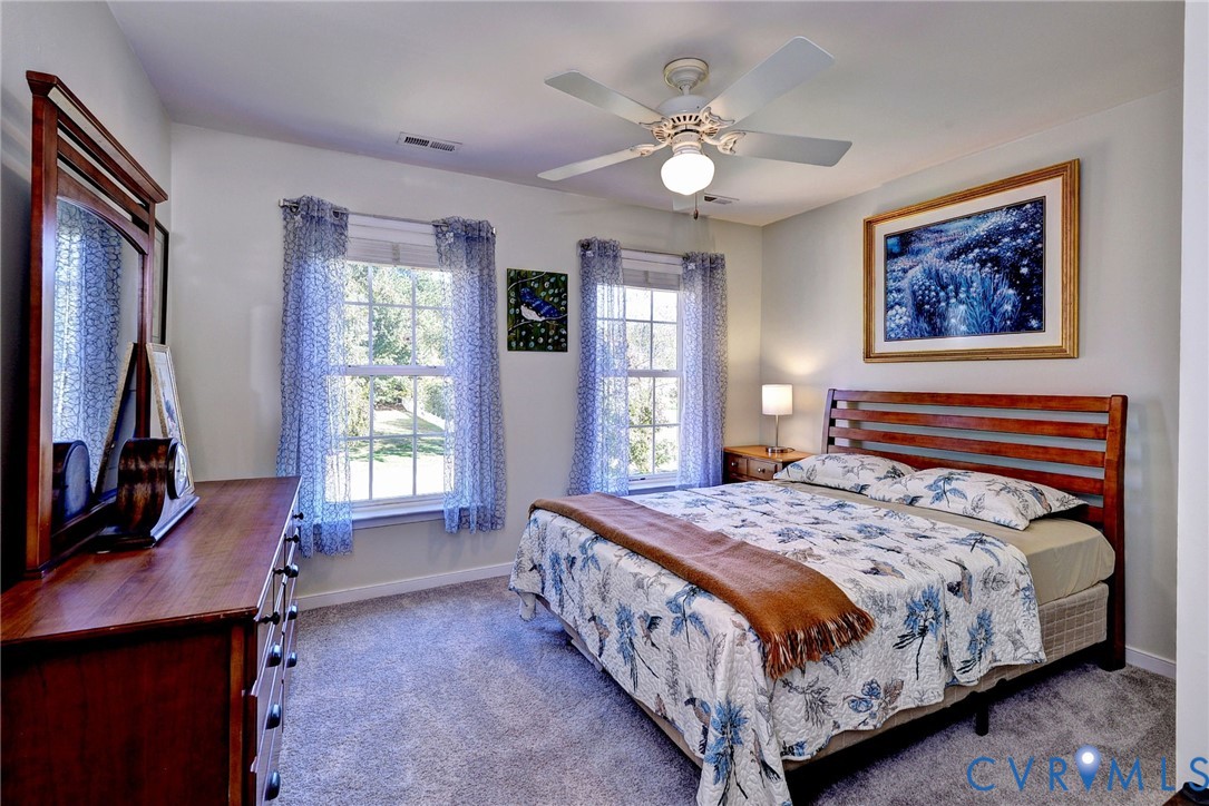 9405 Ashlock Court Toano, VA 23168 - Photo 29 of 43 a bedroom with a bed a computer on desk and a dresser