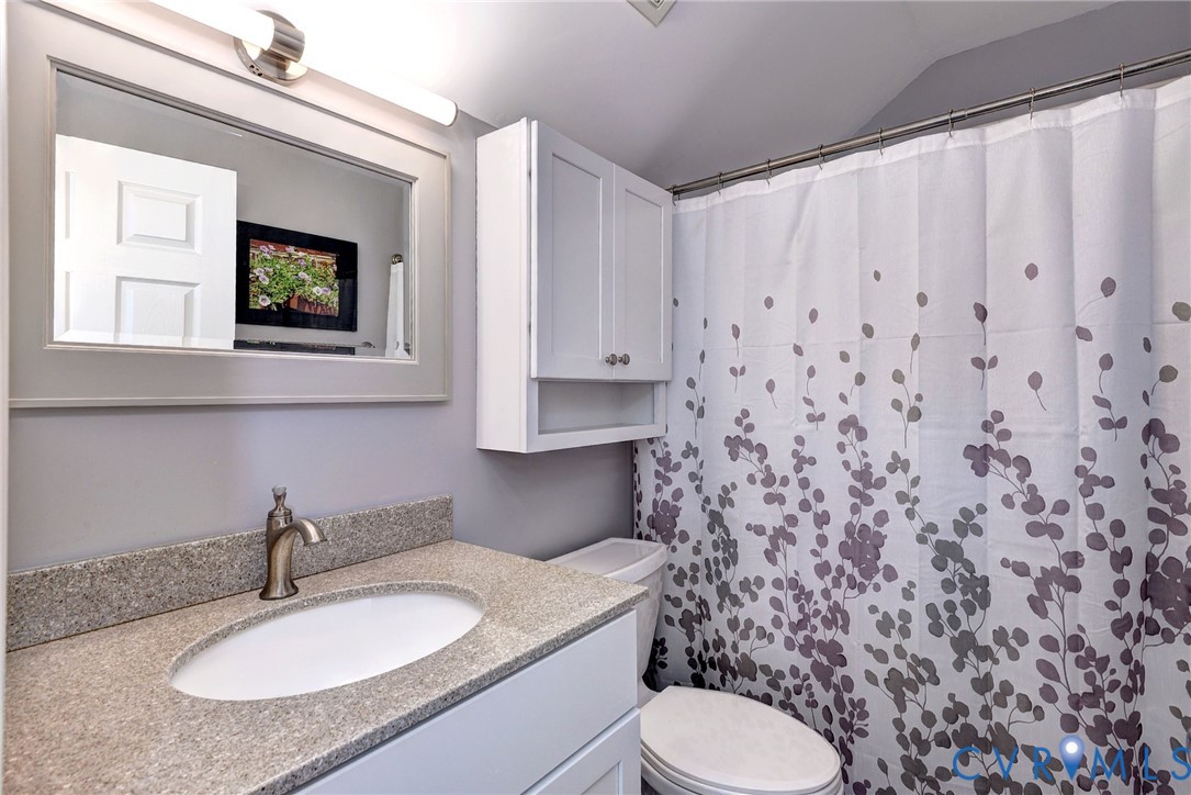 9405 Ashlock Court Toano, VA 23168 - Photo 33 of 43 a bathroom with a granite countertop sink and a toilet