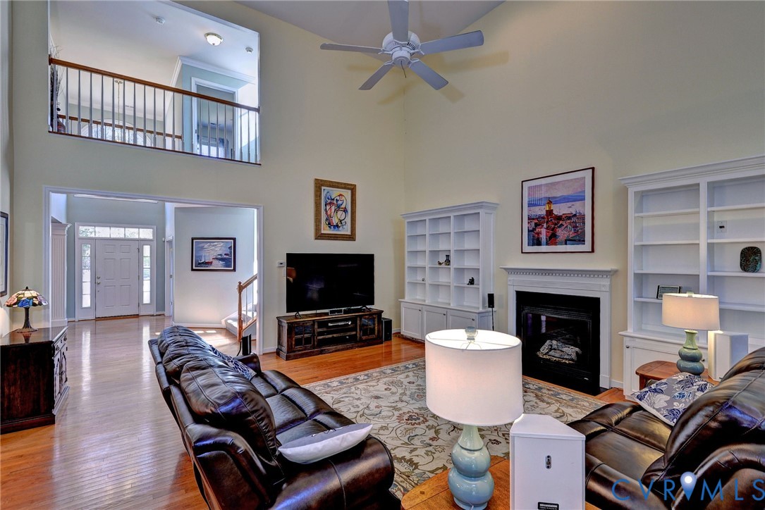 9405 Ashlock Court Toano, VA 23168 - Photo 8 of 43 a living room with furniture a flat screen tv and a fireplace