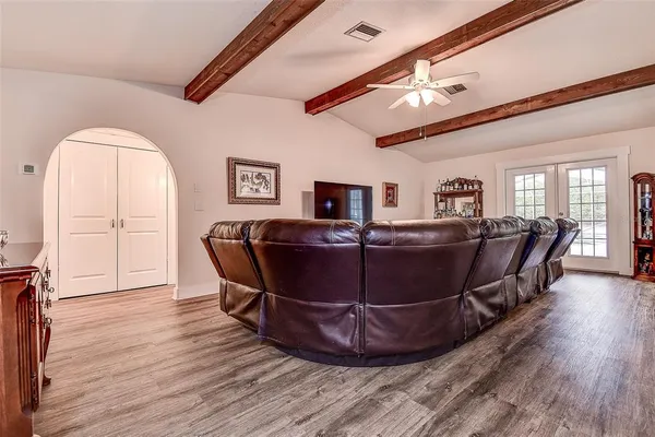 a living room with furniture and wooden floor