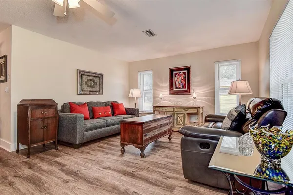 a bedroom with a bed and dresser with mirror