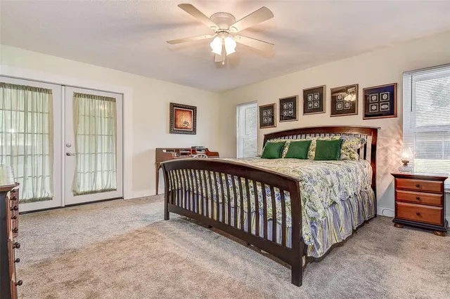 a bedroom with a bed and dresser with mirror