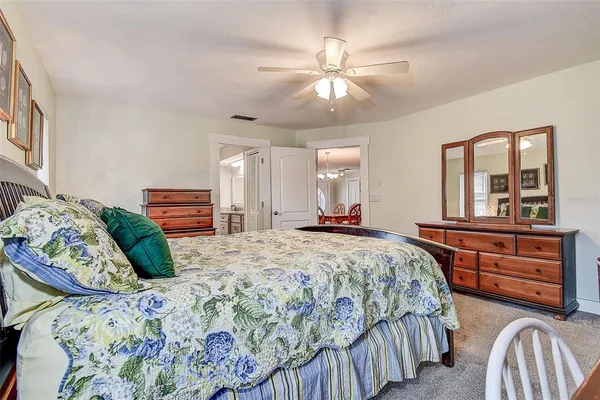 a bathroom with a granite countertop sink a toilet and a mirror