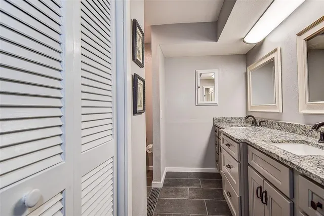 a bathroom with double sink and a mirror