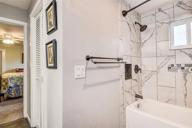 a spacious bedroom with a bed and a chandelier