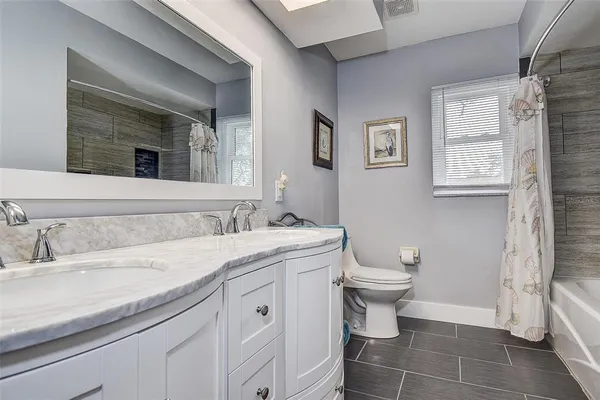 a view of a dining room with furniture wooden floor and windows
