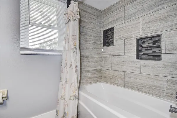 a living room with furniture a window and gym equipment