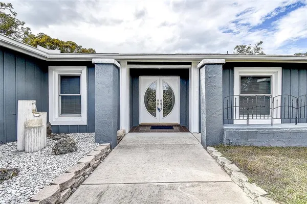 a kitchen with granite countertop white cabinets stainless steel appliances and a sink