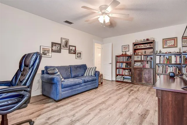 a view of a dining room with furniture wooden floor and windows