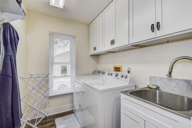 a living room with furniture a ceiling fan and a flat screen tv
