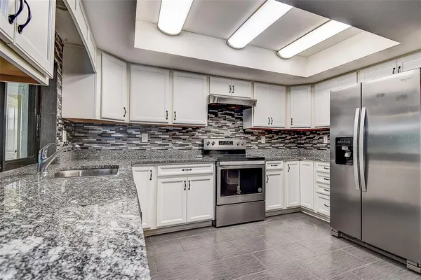 a room with wooden floors table and chairs
