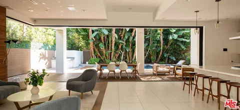 a living room with furniture and large windows