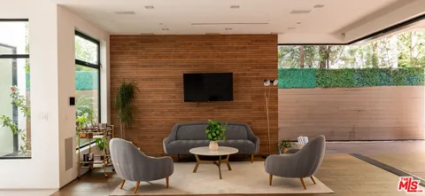 a brick room with furniture and a fireplace