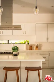 a kitchen with a sink and a refrigerator