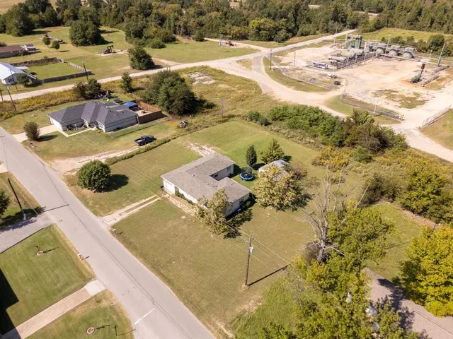 an aerial view of residential houses with outdoor space