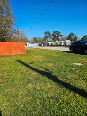 a view of a yard with a house in the background