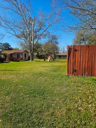 a view of a backyard with large trees