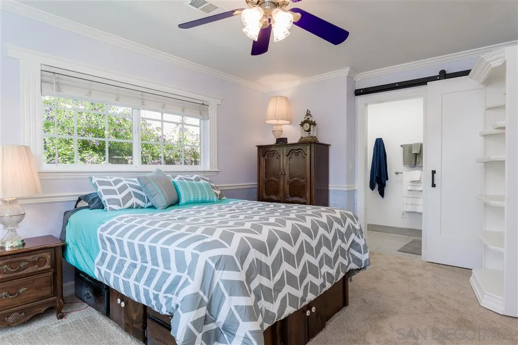 5168 Constitution Road San Diego, CA 92117 - Photo 13 of 25 a bedroom with a large bed and a chandelier