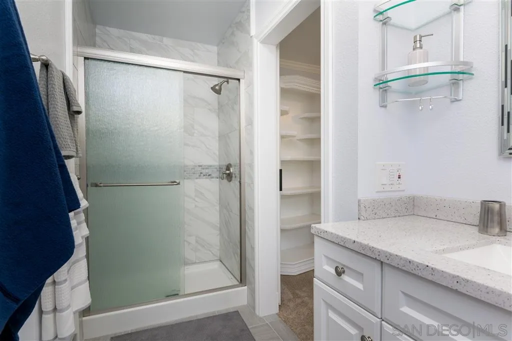 5168 Constitution Road San Diego, CA 92117 - Photo 14 of 25 a bathroom with a granite countertop shower mirror and a sink