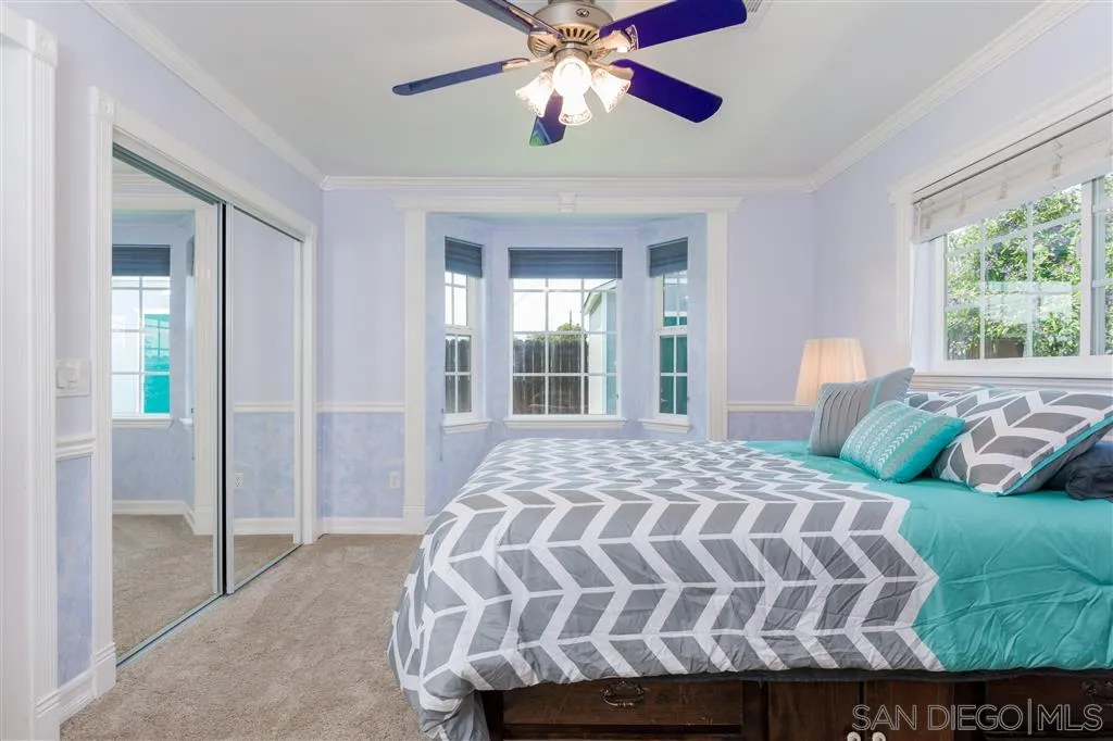 5168 Constitution Road San Diego, CA 92117 - Photo 16 of 25 a bedroom with a large bed and a chandelier