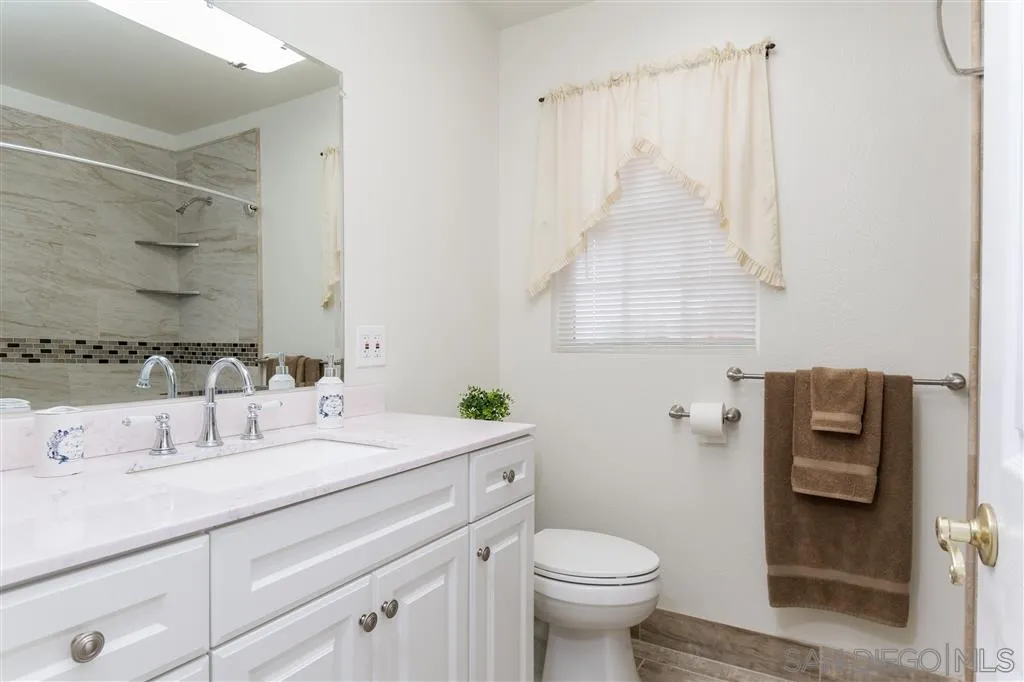 5168 Constitution Road San Diego, CA 92117 - Photo 18 of 25 a bathroom with a sink toilet and shower